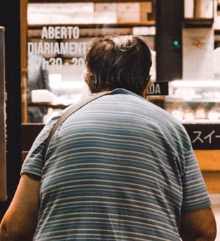 Photo of a stooped person entering a shop