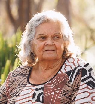 Photo of a woman in an earthy print top outdoors