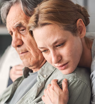 Photo of a young person embracing an older person