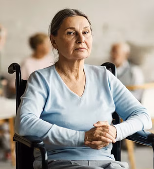 Photo of a woman wearing a baby blue top in a wheelchair