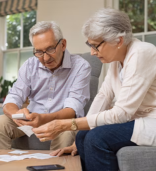 Photo of couple looking at receipts together