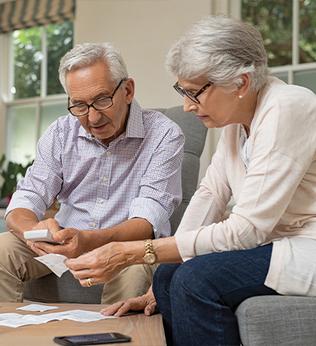 Photo of couple looking at receipts together