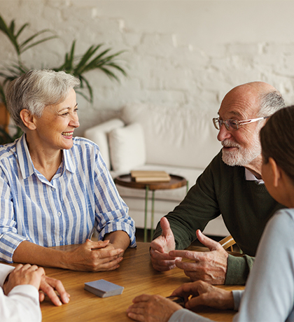 Photo of people sitting at a table smiling