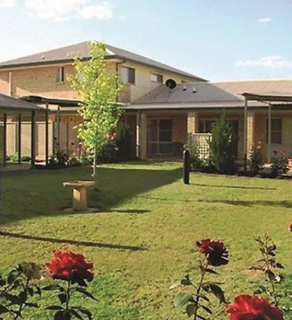 Photo of a group of buildings surrounding a rose garden