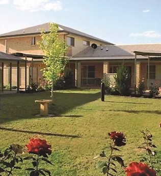 Photo of a group of buildings surrounding a rose garden