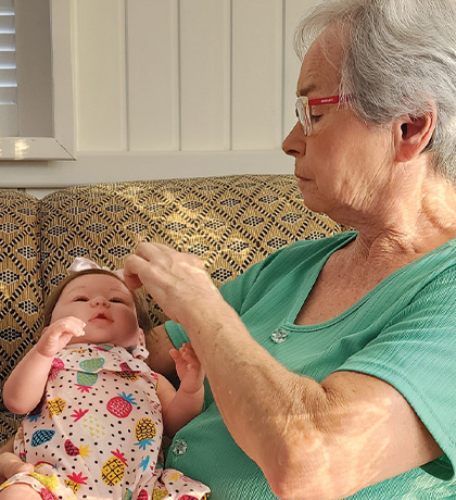 Photo of a woman with a baby doll