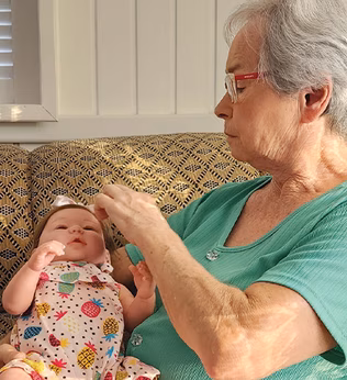 Photo of a woman with a baby doll