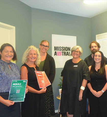 Photo of a group of smiling people in an office
