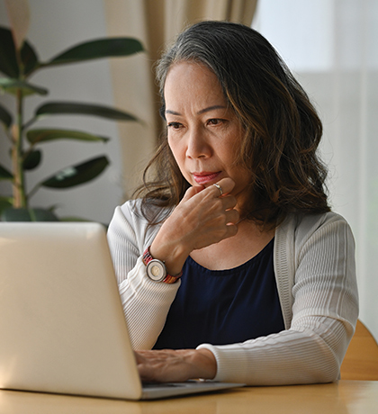 Photo of a woman sitting in front of a laptop