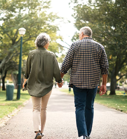 Free Course for Mental Health - man and a woman walking in a park and holding hands.