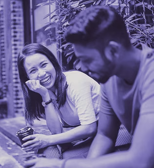 Photo of two people laughing together