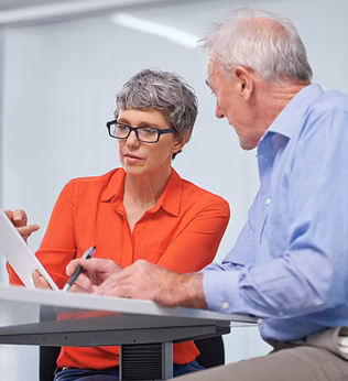 Photo of a woman in an orange shirt and a man wearing blue