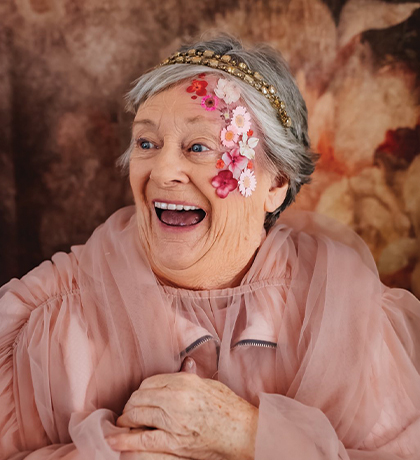 Photo of a woman wearing dusty rose organza and flowers
