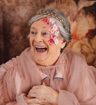 Photo of a woman wearing dusty rose organza and flowers