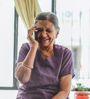 Photo of woman wearing a purple top and a cream bracelet