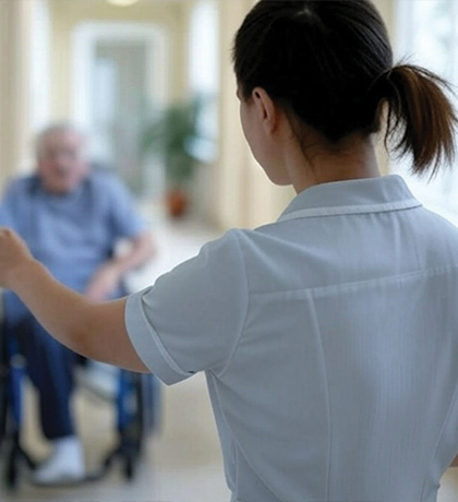 Photo of a nurse looking through a door at a patient