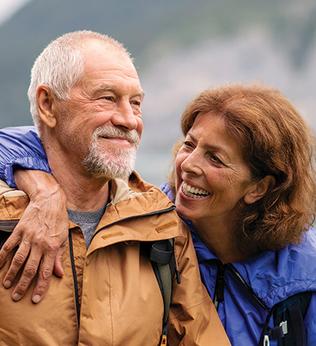 Photo of a couple in smiling in wet weather gear
