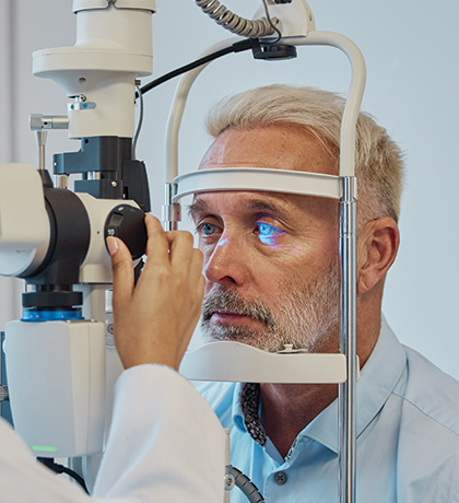 Photo of an optometrist checking a man's eyes with a machine