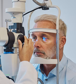 Photo of an optometrist checking a man's eyes with a machine