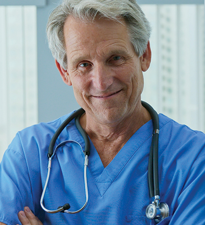 Photo of man in blue scrubs with stethoscope