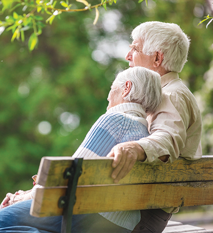 Photo of a couple sitting together on a park bench