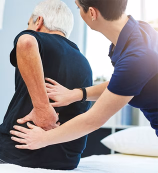 Photo of a physio helping a man with his back