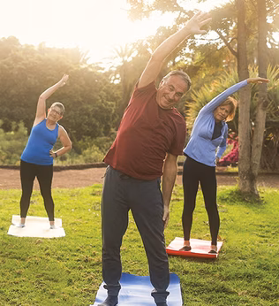 Photo of a group fitness class stretching outdoors