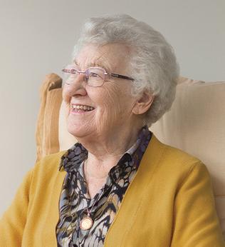 Photo of a woman in a mustard cardigan