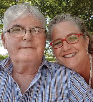 Photo of a smiling couple in a green park
