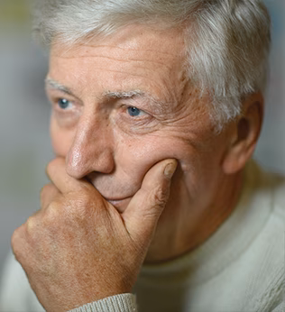Photo of a man holding his chin in his hand