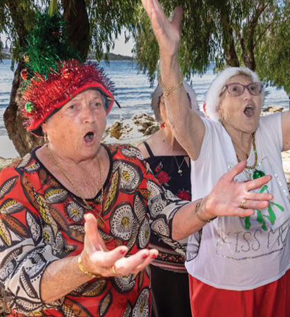 Photo of women singing with gusto on a beach