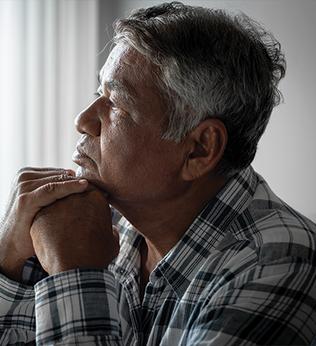 Photo of a pensive man in a plaid shirt