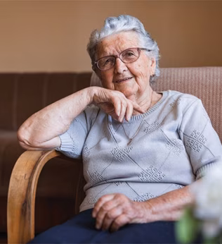 Photo of a smiling woman sitting in an arm chair