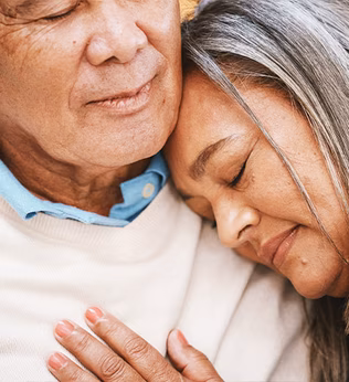 Photo of woman resting her head on a man's shoulder