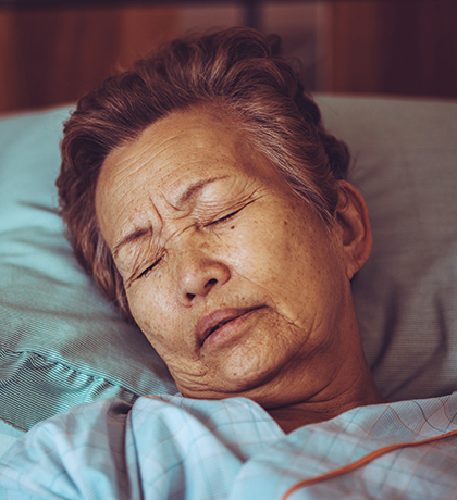 Photo of a woman asleep in a hospital bed