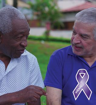Photo of two men chatting outdoors