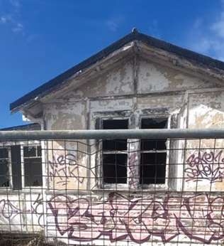 Photo of a vandalised abandoned house