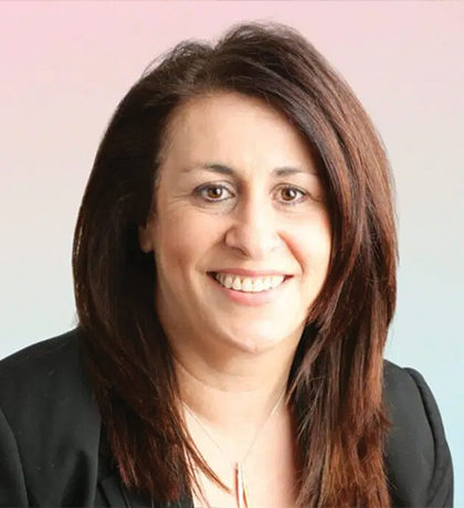 Photo of a woman wearing a suit jacket smiling