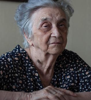 Photo of a woman with blurry flowers in the foreground