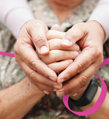 Image of a younger person holding the hands of an older person