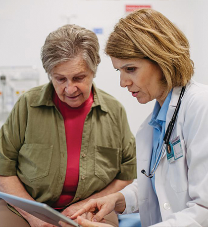 Photo of a doctor an patient looking at a computer tablet together