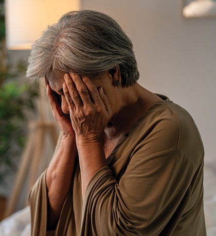 Photo of a woman pressing her hands to her face
