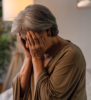 Photo of a woman pressing her hands to her face