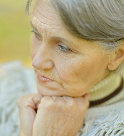 Photo of a woman wearing a fringed grey jumper