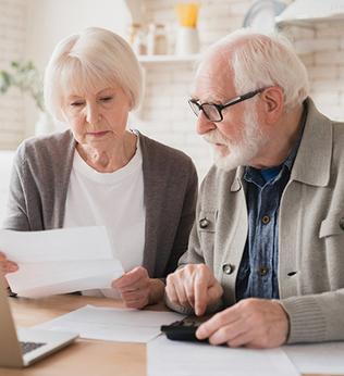 Photo of couple looking at paperwork in a light filled room