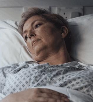 Photo of a woman lying in a hospital bed