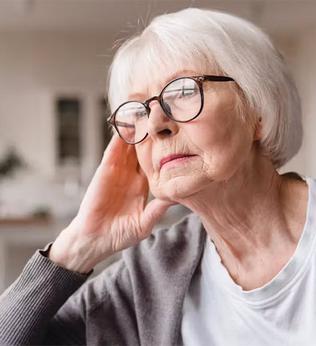 Photo of woman with glasses looking pensive