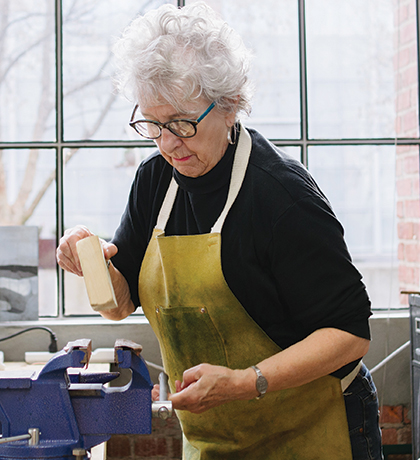 Photo of a woman in a light filled workshop