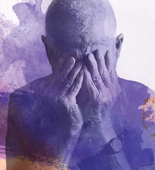 Photo of a man with his hands over his eyes