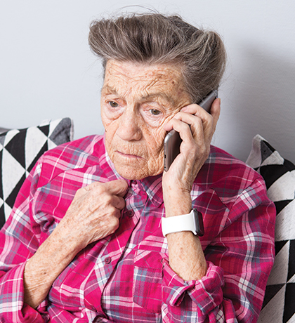 Photo of person on a mobile phone wearing a fuchsia plaid shirt